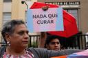 A member of the LGBTQ+ community holds up a sign with a message that reads ‘Nothing to cure’, during a protest in Lima, Peru (AP Photo/Martin Mejia)