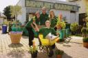 Wheelie thankful – Claudia Acevedo, owner Nick Chalkley, and Rayner Wilding give Emma Smith a lift in a wheelbarrow