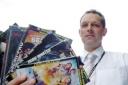 trading standards officer Carl Robinson with confiscated fake DVDs