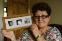 Memories – Angie Guy with a photo of her cats, with Polo in the centre