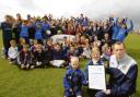 Award time — Essex County FA club development officer Ian Bent and Kyle Williams, five, and Rebecca Ashley, seven, with the FA Charter Standard Develop-ment status award bestowed on Forest Glade