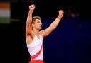 Max Whitlock celebrates at the end of a stylish floor routine