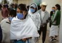 Many Mexicans are wearing face masks in the street to try to protect themselves from swine flu