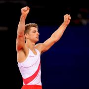 Max Whitlock celebrates at the end of a stylish floor routine