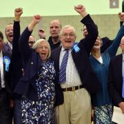 Tories celebrate after Stephen Hillier (centre) retains his seat by only two votes from Ukip