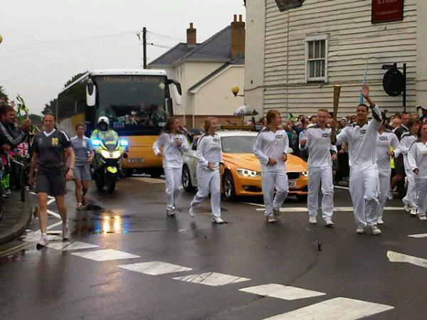 Olympic Torch heads through Rayleigh High Street to cheers and waves from the crowds. Torchbearers from the FitzWimarc School. Picture courtesy of Rochford DC.