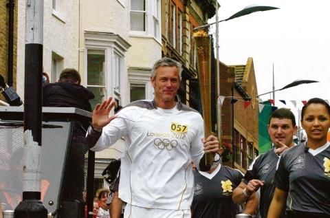 Echo: Mark Foster carrying the Olympic flame through Southend last week