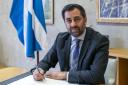 Outgoing First Minister Humza Yousaf signs his official resignation letter to the King (Jane Barlow/PA)