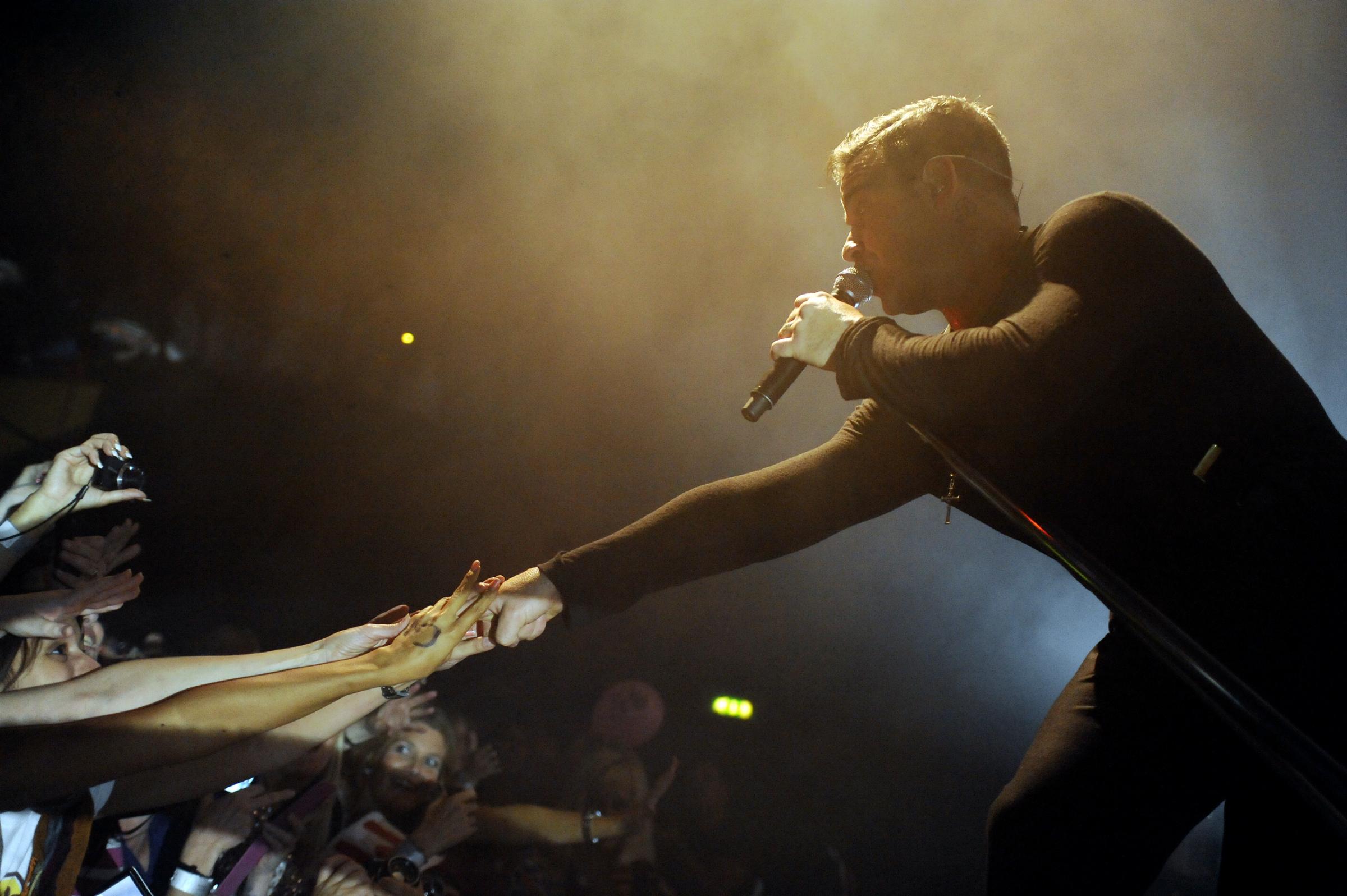 Reaching out - Robbie Williams mingles with his fans during a concert held at the Cliffs Pavilion in 2012