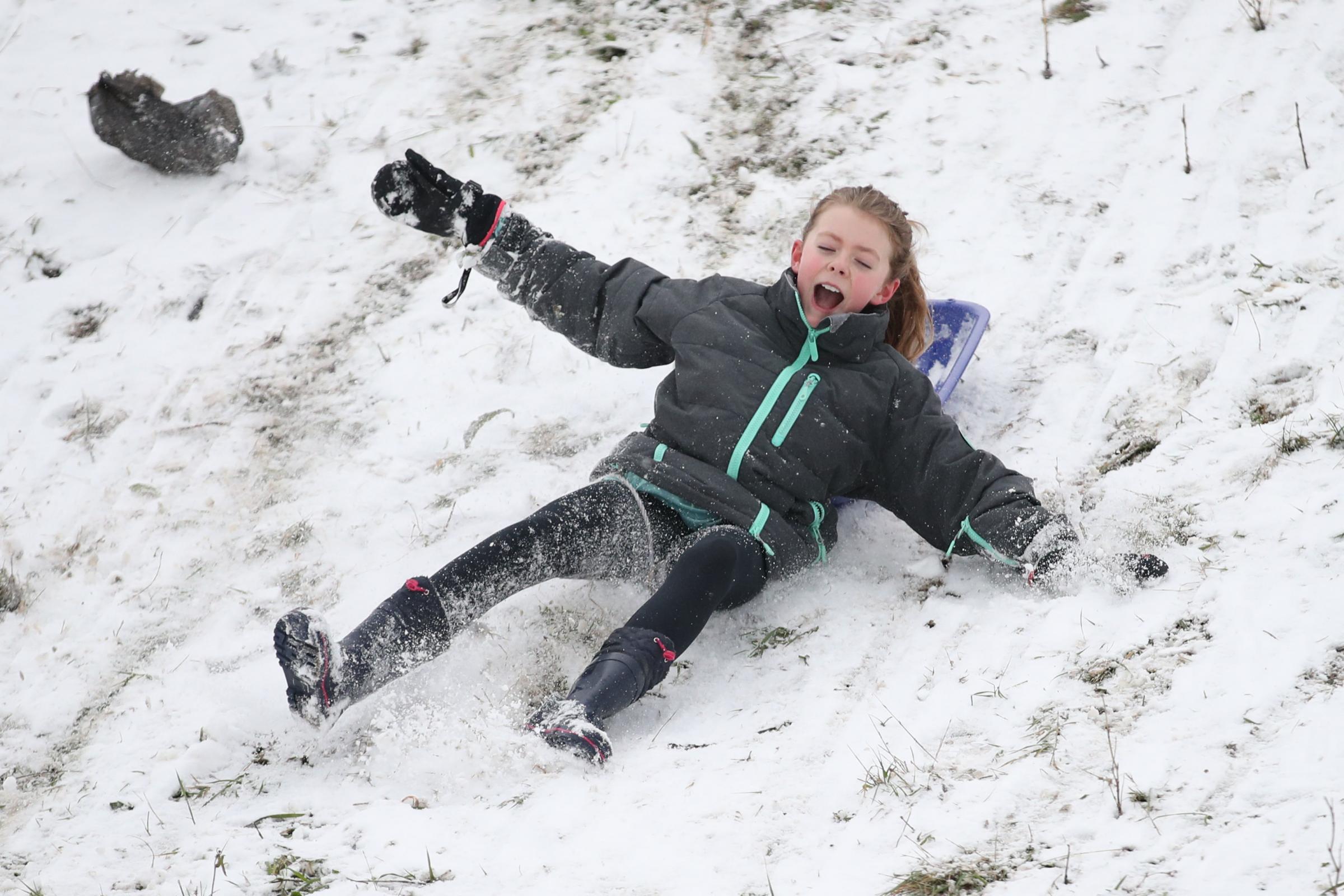 Amy Heather, aged 10, sledging near the seafront at Southend. Picture: Yui Mok/PA Wire