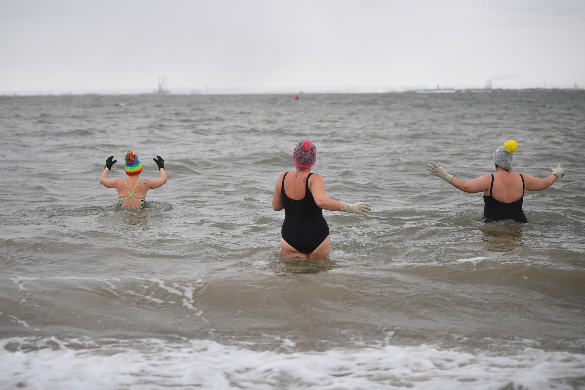 Early morning swimmers Victoria Carlin, Sallyann Manthorp and Peta Hunter, take a dip in the water, which is 1.4 degrees centigrade. Picture: Victoria Jones/PA Wire 