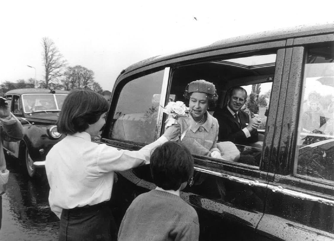 Gift - the Queen accepts flowers during a visit to South Woodham Ferrers in May 1981