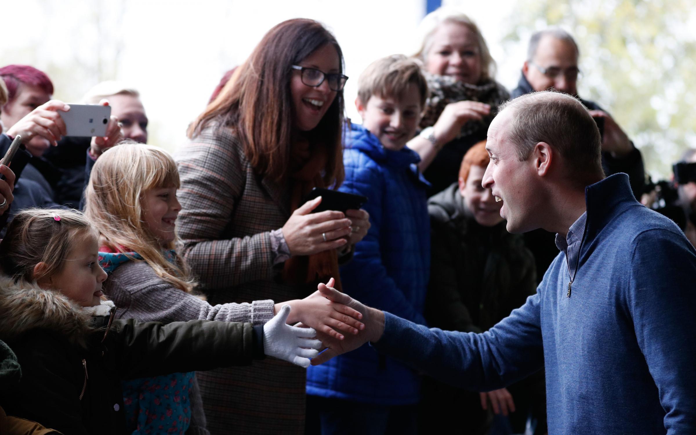 Friendly faces - Prince William, the Duke of Cambridge, says hello to two excitable youngsters when he paid a visit to Basildon Sporting Village in 2018