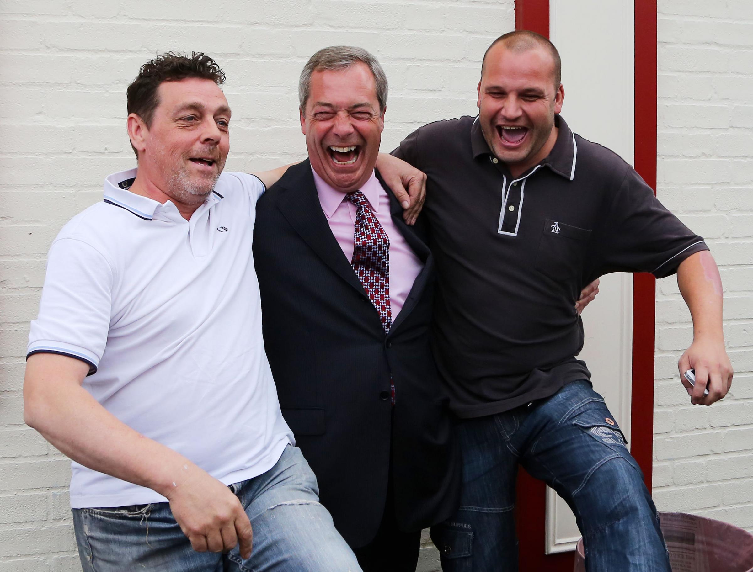 Laughter - former Ukip leader Nigel Farage celebrates with two supporters during a visit to Basildon in May 2014