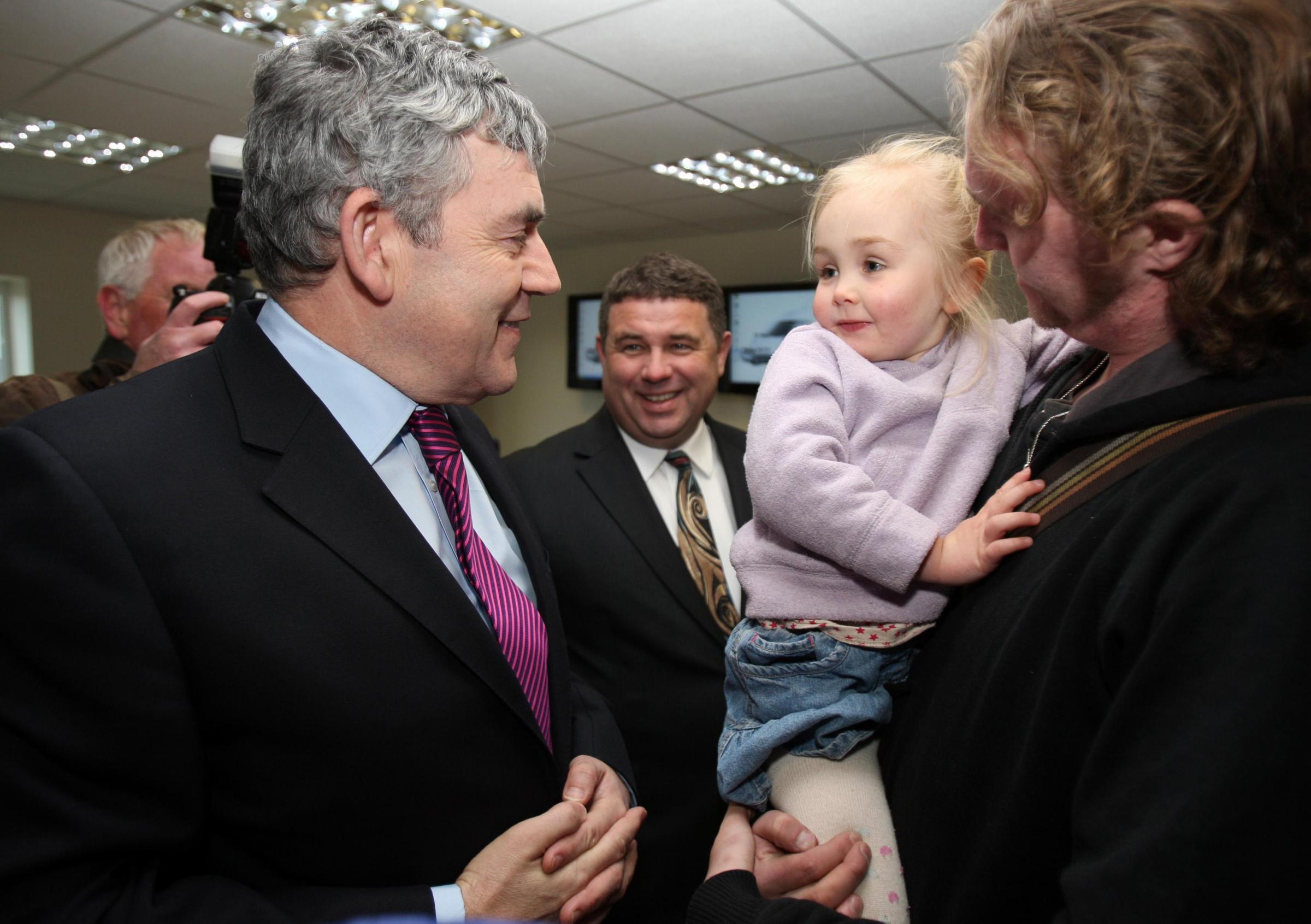 Friendly face - then-Prime Minister Gordon Brown meets three-year-old Eva Mansfield and her father Paul Mansfield during a visit to Basildons Abby Couriers