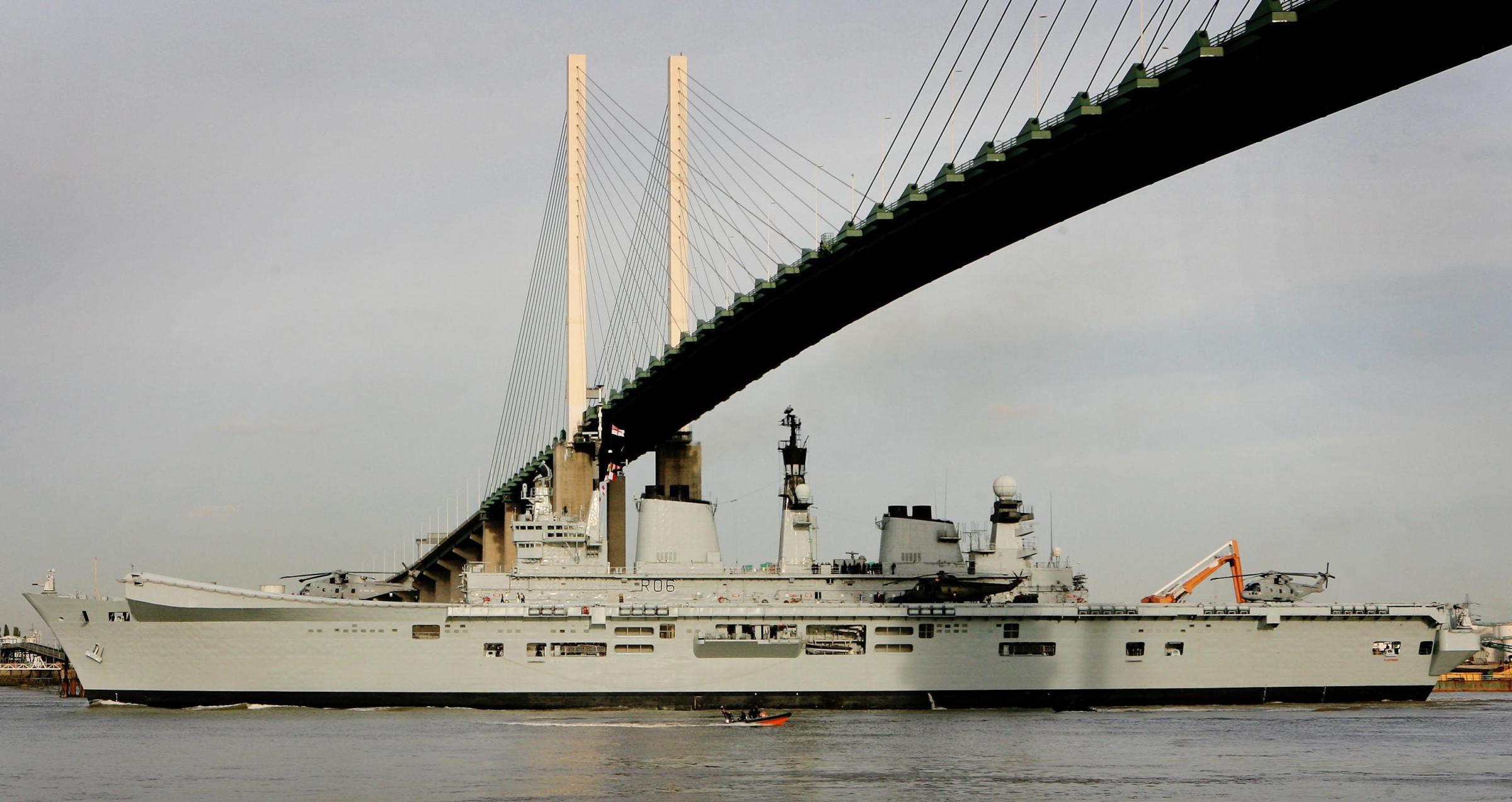 Sailing below - Royal Navy flagship HMS Illustrious goes under the QEII ahead of taking part in the 2006 Remembrance Day commemorations