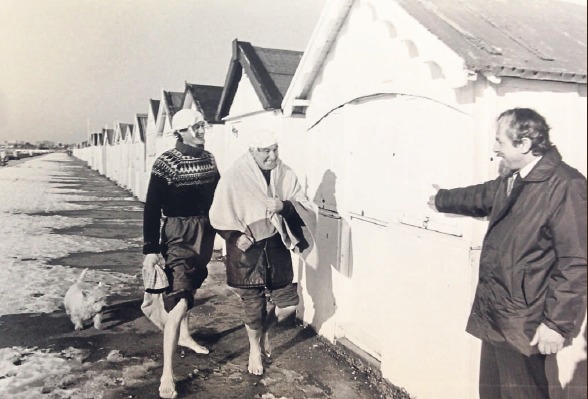Hankies – brave seaside goers walking alongside the beach huts as snow turned to ice in 1982