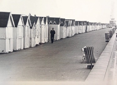 Atmospheric - a south Essex resident walks in front of the Shoebury beach huts in 1980