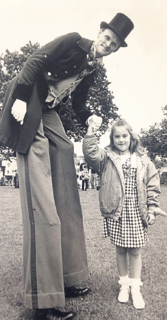 Little and large - stilt walker Paul St George meets seven-year-old Victoria Harrison at a Benfleet fete in June 1991