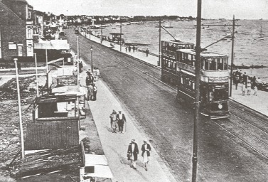Vintage - a tram passes residents along Thorpe Bay seafront in the 1920s
