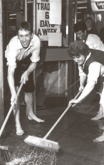 Floods - staff cleaning water out of Rayleighs International Stores after the heavens opened in July 1981