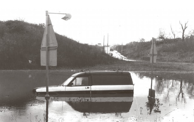 No way through - a car is submerged in floodwater in December 1982