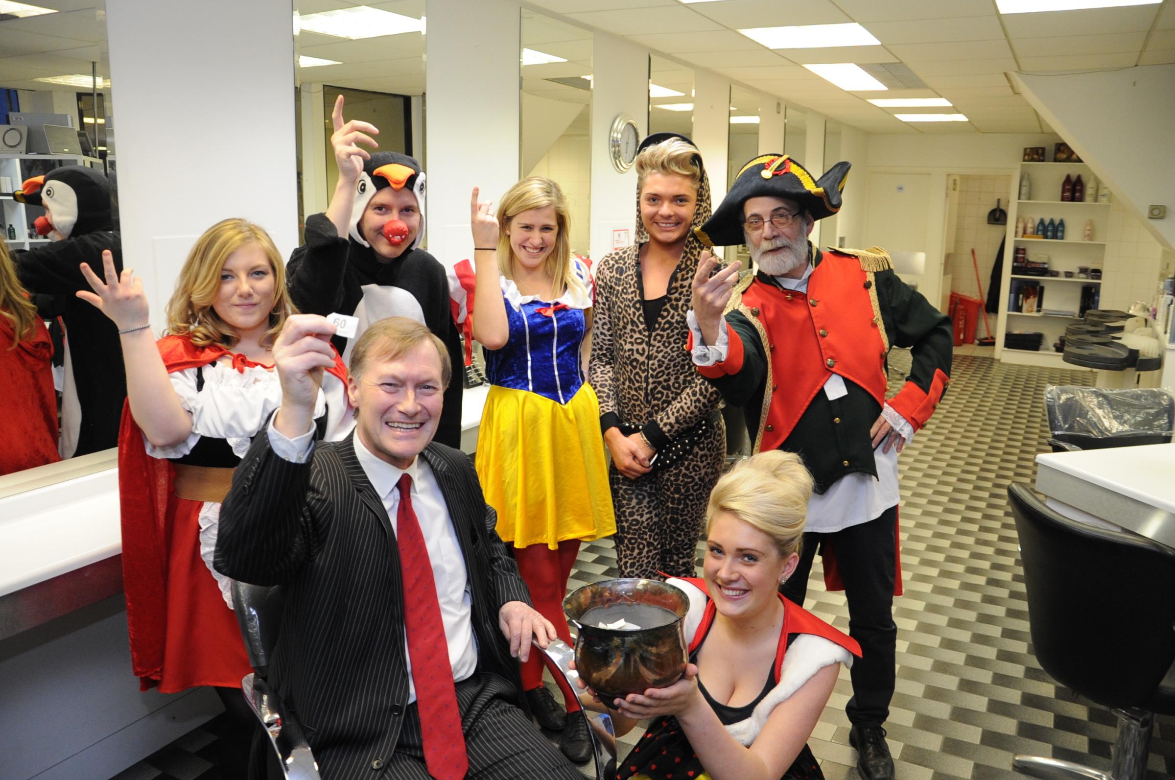 We have a winner - Sir David Amess picks the triumpant raffle ticket at a hairdressers fundraising event in Leigh eight years ago