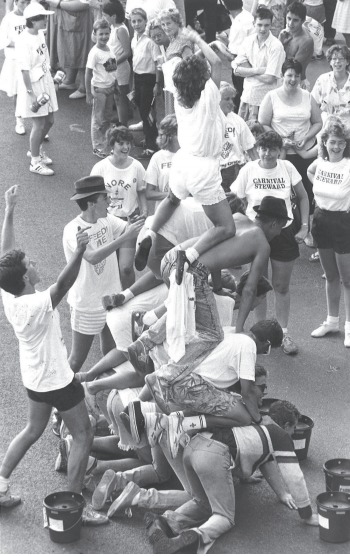 Dangerous - scouts look to build a human pyramid as worried carnival stewards watch on