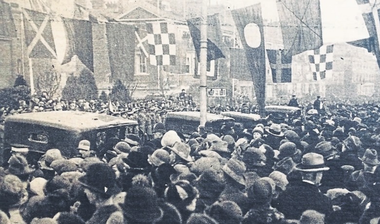 Crowds and flags - more than 1,000 people line the streets to see the Prince open the road 96 years ago