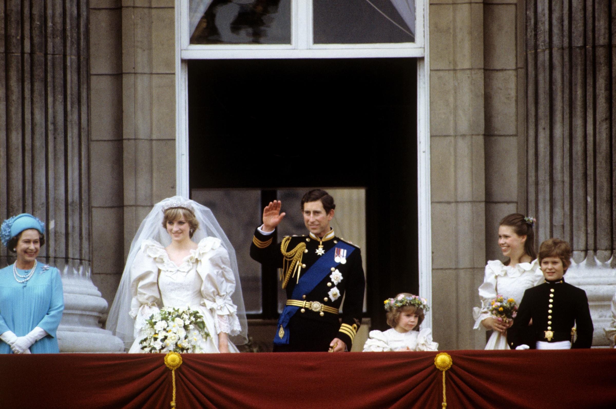 Waving to well-wishers - Prince Charles and Princess Diana on the Buckingham Palace balcony after their wedding