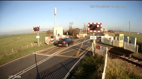 Video footage showed the moment careless driver Andrew Bryant narrowly escaped being crushed by a train in his Volkswagen at a level crossing in Sussex