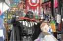 Lightsaber - Darth Vader cuts client Bob Clark's hair at the Simon Foxen Barber Shop Picture: MICHAEL WALKER