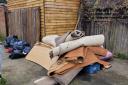 Fly-tipped rubbish is blocking access to an elderly Basildon woman's home, her son has claimed.