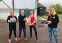 Hand over - Rhys Gillard of Southend AC receives a defibrillator from Mark Benham and fellow trustees Anne Purdham and Nicki Benham
