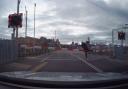 Shocking - the dashcam footage shows the man jump over both barriers at the Hythe Station level crossing
