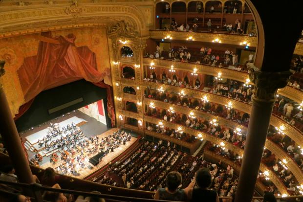 Echo: A grand theatre with people watching an orchestra. Credit: Canva