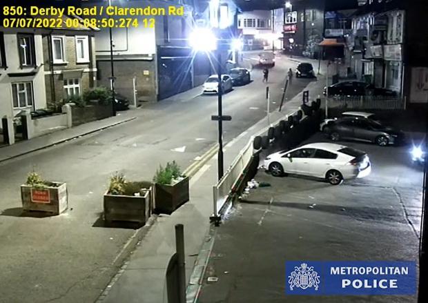 Echo: CCTV of of Owami Davies crossing Derby Road, West Croydon in the company of a man in front of a white van. Photo: Metropolitan Police / PA Wire
