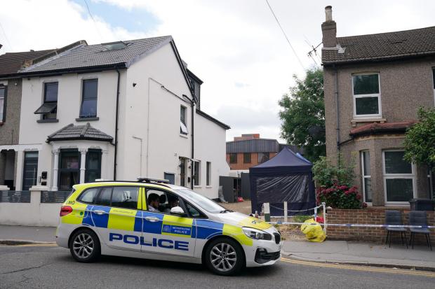 Echo: Police outside a property on Derby Road, West Croydon. Photo: Metropolitan Police / PA Wire