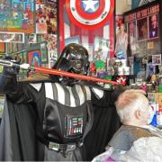 Lightsaber - Darth Vader cuts client Bob Clark's hair at the Simon Foxen Barber Shop Picture: MICHAEL WALKER