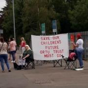 Protestors pictured outside the school gates today