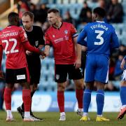 Report - Colchester United defender Junior Tchamadeu speaks with referee Sam Purkiss to report an incident of alleged racial abuse during the game at Gillingham Picture: RICHARD BLAXALL