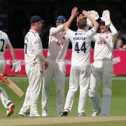 Posing problems - Jamie Porter of Essex celebrates with his team mates after taking the wicket of Ollie Pope