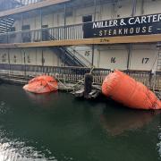 Photo shows Lakeside's popular floating Miller and Carter restaurant raised