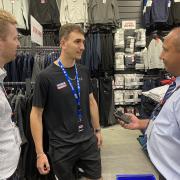 Partnership - Business crime officer PC Alex Plakhtienko, right, and Will Garrod, operations manager for ShopSafe, , left, discussing TownLink with Sports Direct store supervisor Ben Arnold in Canvey Island