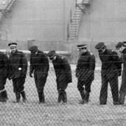 Hunting for evidence - Police can be seen combing the Texaco site after the bombing