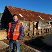 Shipyard manager John Evans keeps 'a nautical eye' over the conversion of retired Thames barges into plush houseboats.