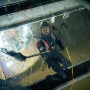 High up - workers from LDT Contractors cleaning Tower Bridge’s glass floors
