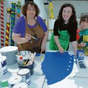 Arty fun – Tina Judd with daughters Sarah, 13, and Isabel, eight, painting scenery at an earlier workshop