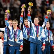 Max Whitlock, second from left, stands on the podium with his Olympic bronze medal.