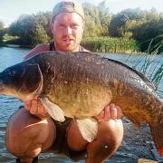 Success – for Alan Slade who is pictured showing off his mirror carp